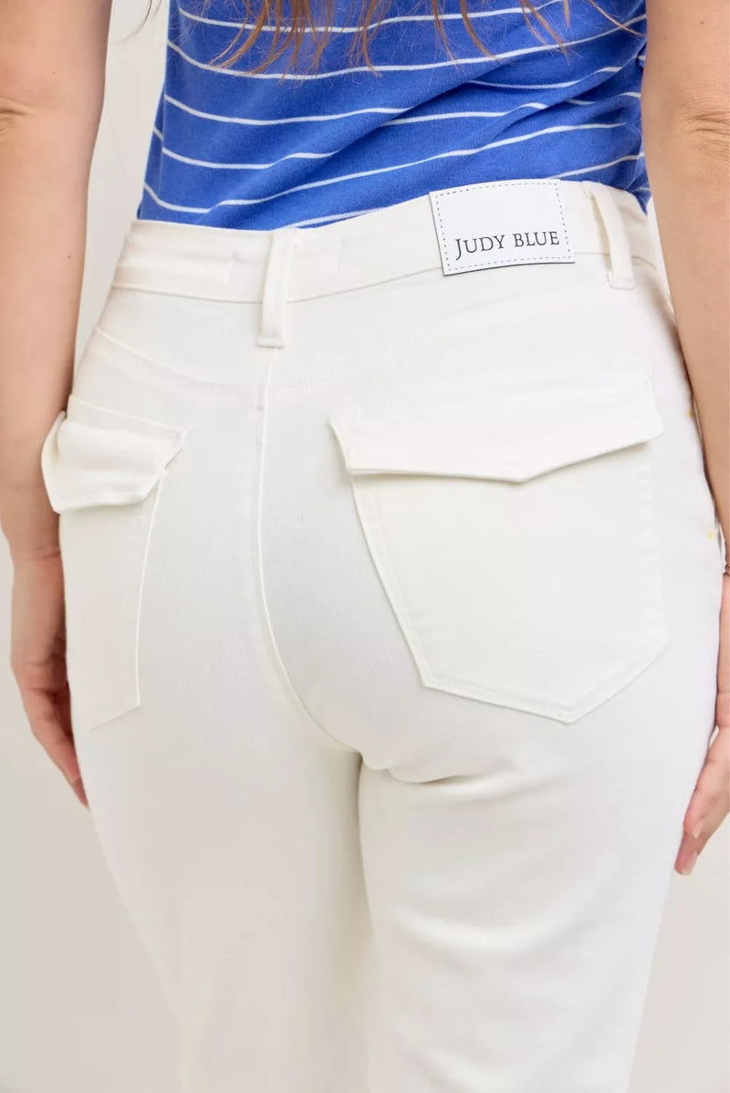 White pants with a visible brand label on a neutral background