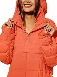 Person wearing an orange puffer jacket on a white background