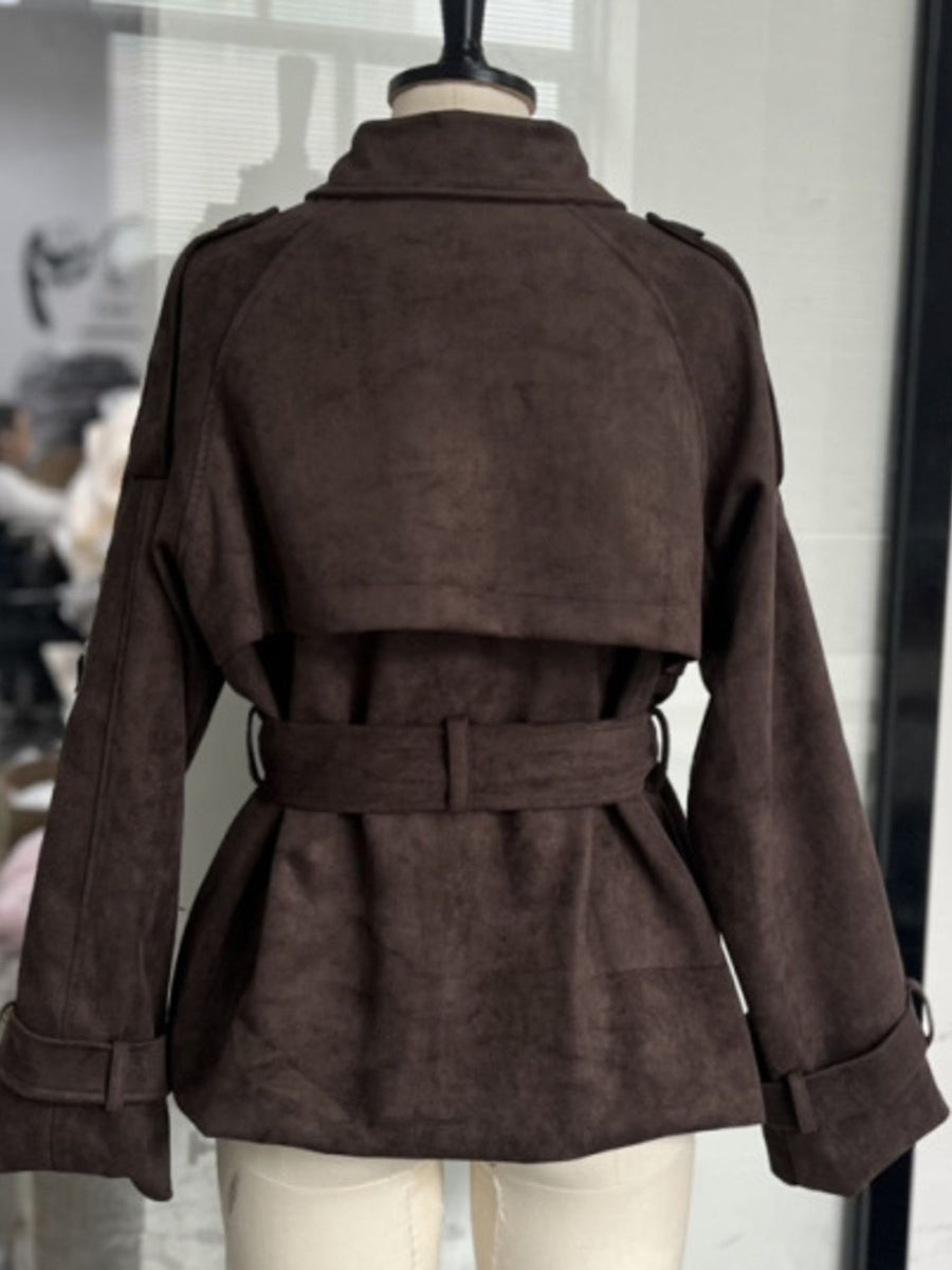 Brown suede jacket on a mannequin against a neutral background