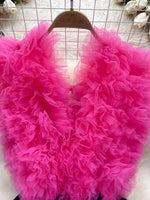 Pink fluffy garment on a hanger against a white background