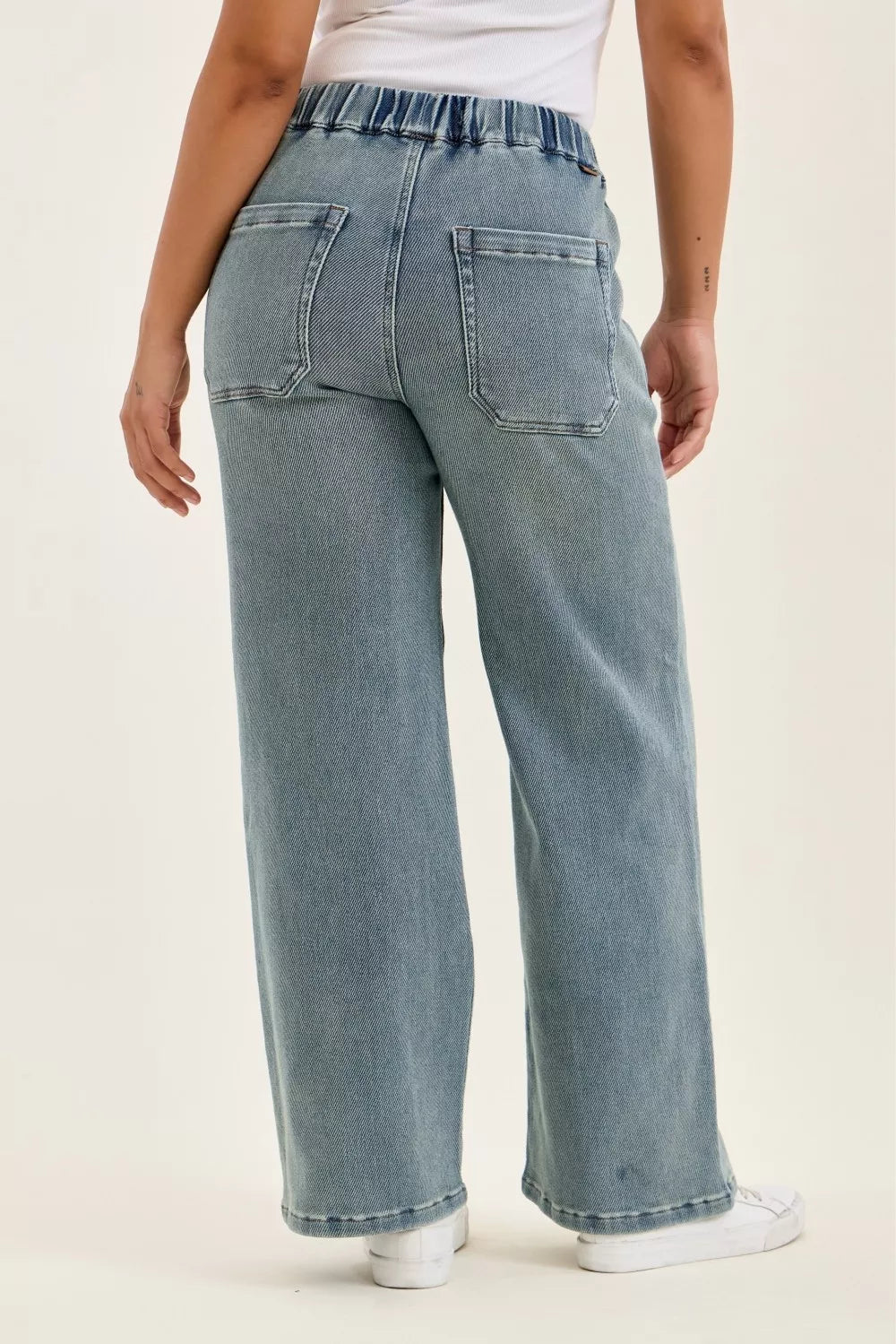 Light blue jeans worn by a person on a white background