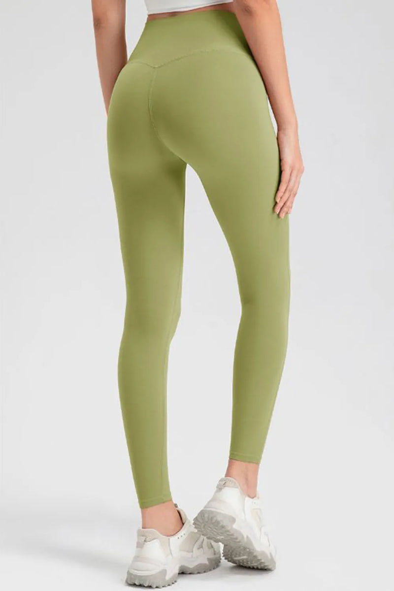 Green leggings worn by a person on a white background