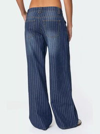 Blue pinstripe jeans worn by a person on a white background