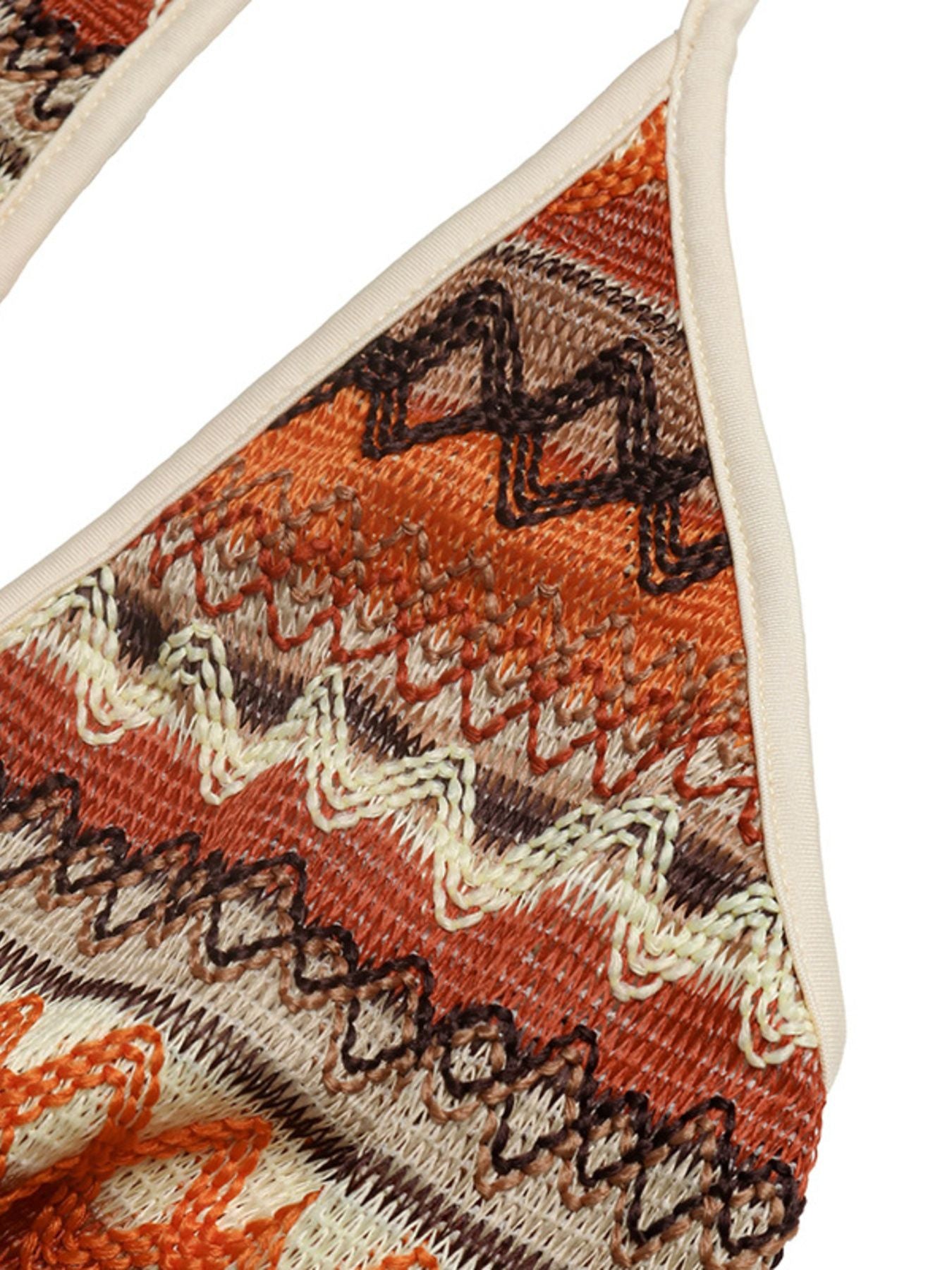 Close-up of a patterned sandal with orange, brown, and beige colors on a white background.