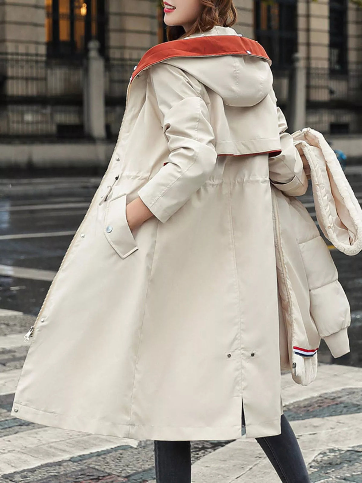 Lady walking up stairs outside in Women's Detachable Longline Hooded Parka with Faux Fur Trim and Drawstring Waist