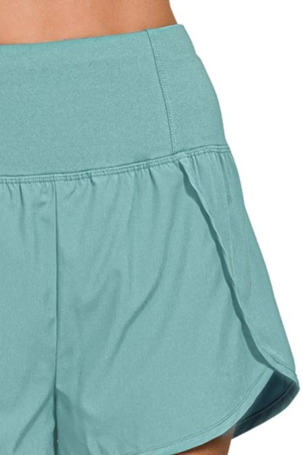 Teal shorts with a white background