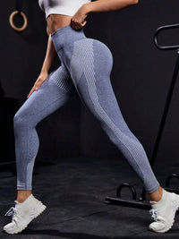 Person wearing blue leggings and white sneakers in a gym setting