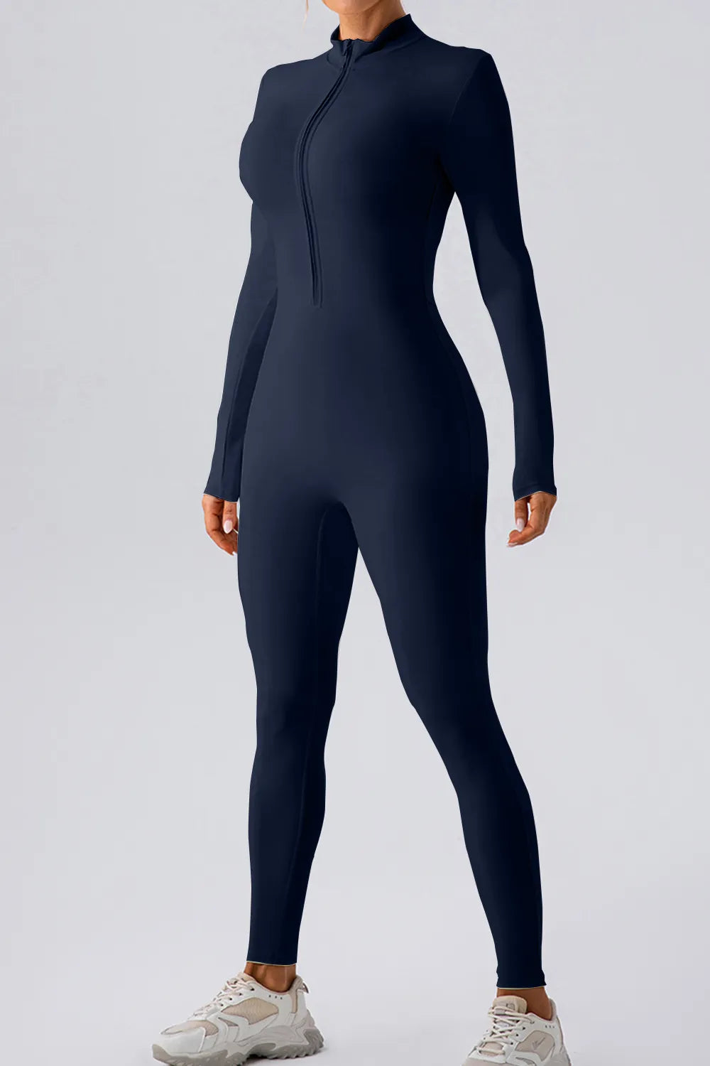 Person wearing a black full-body suit on a light gray background