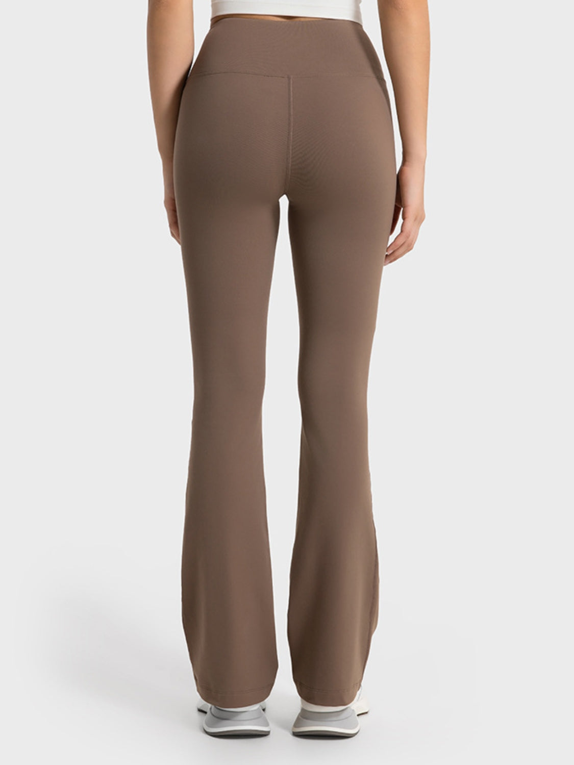 Brown pants worn by a person on a white background