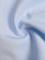 Close-up of light blue fabric with a subtle pattern