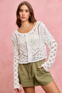 Woman wearing a white lace top and green shorts against a pink background