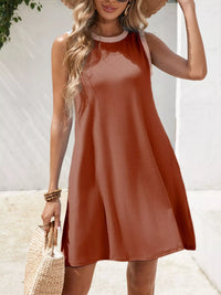 Woman wearing a rust-colored dress with a white background
