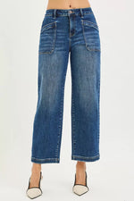 Blue jeans worn by a person on a white background