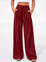 Maroon wide-leg pants worn by a person on a white background
