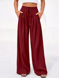 Maroon wide-leg pants worn by a person on a white background