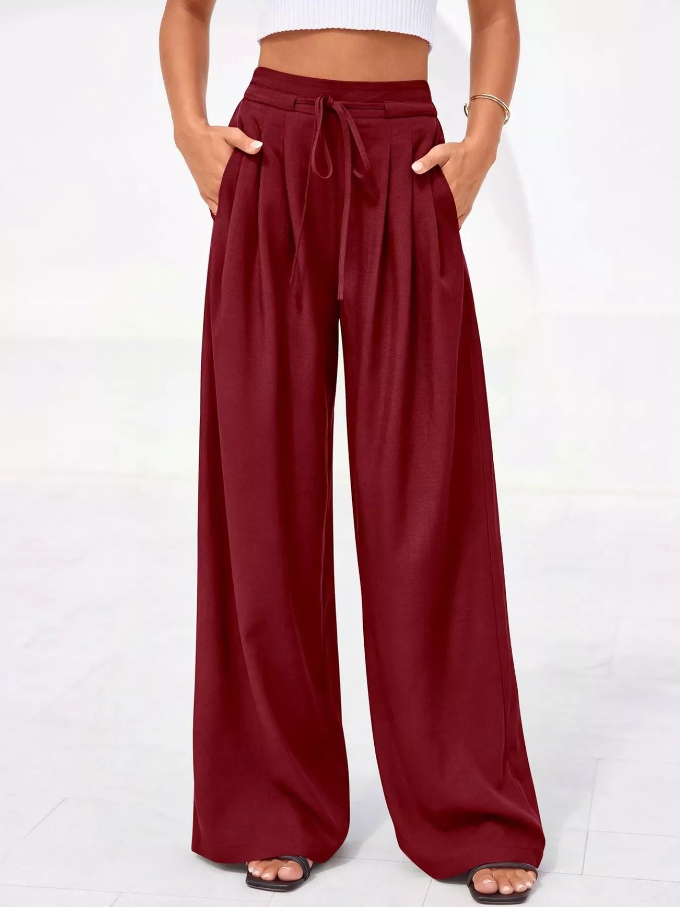 Maroon wide-leg pants worn by a person on a white background