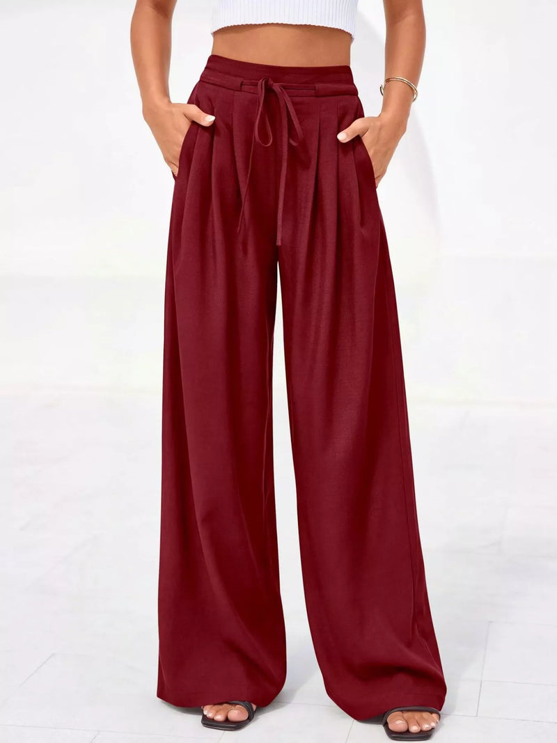 Maroon wide-leg pants worn by a person on a white background