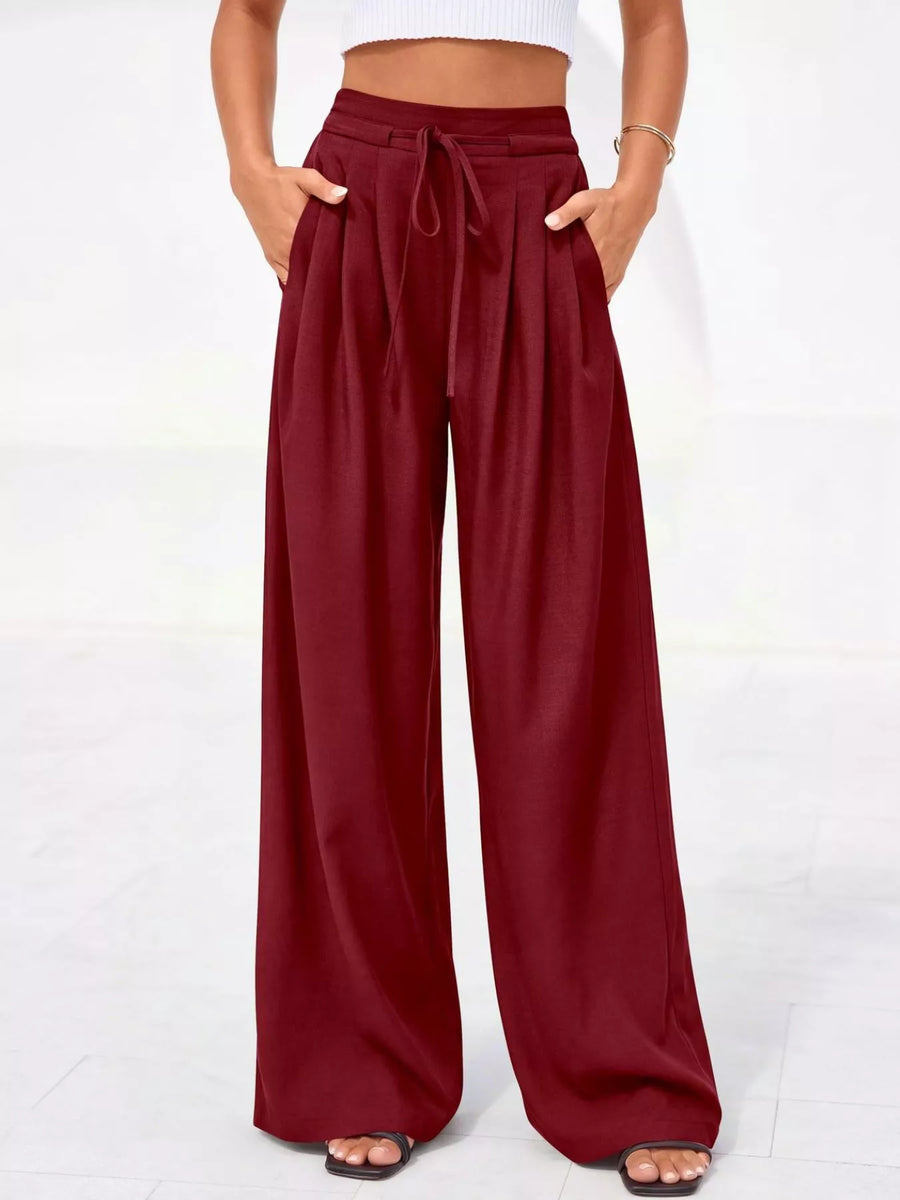 Maroon wide-leg pants worn by a person on a white background
