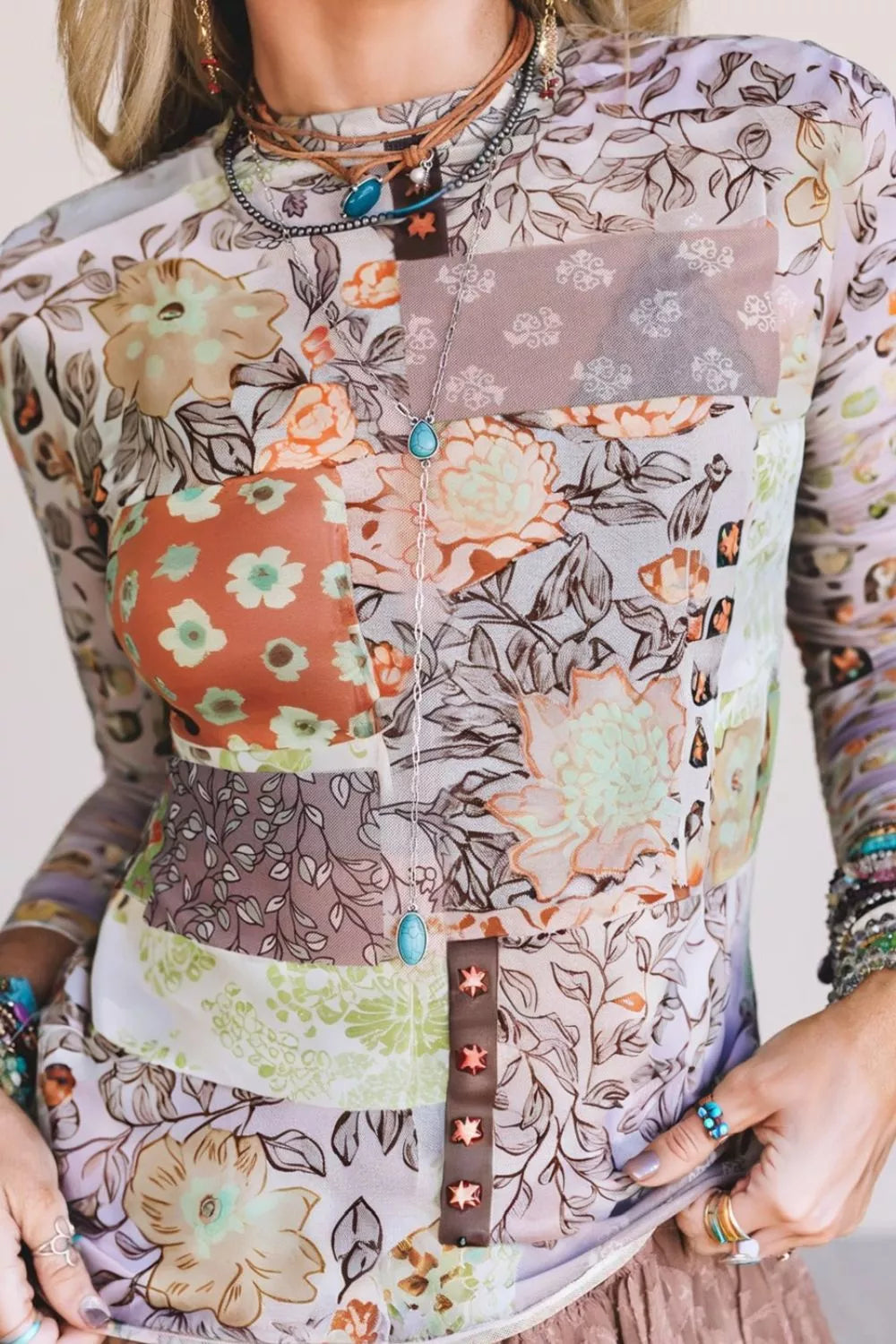 Person wearing a floral patterned shirt with a focus on the chest area.