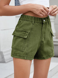 Green cargo shorts worn by a person on a light background