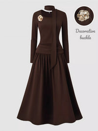 Brown dress with decorative buckle on a white background