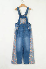 Blue denim overalls with floral pattern on a white background
