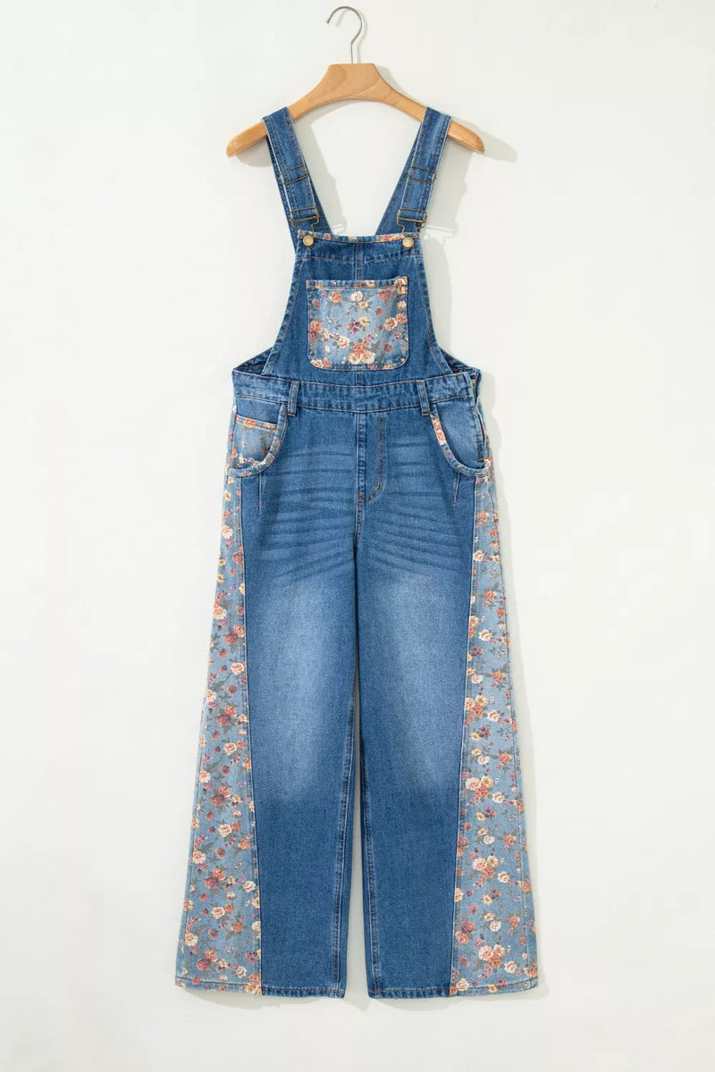 Blue denim overalls with floral pattern on a white background