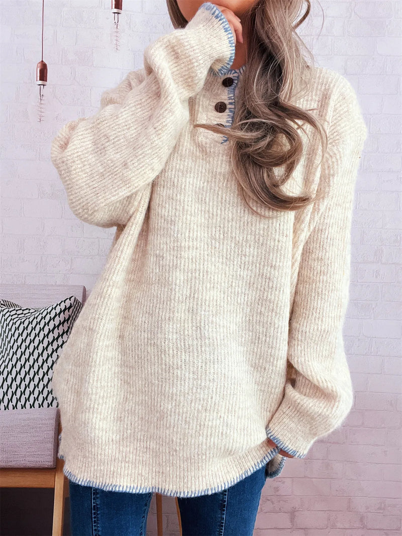 Person wearing a beige sweater with a white background