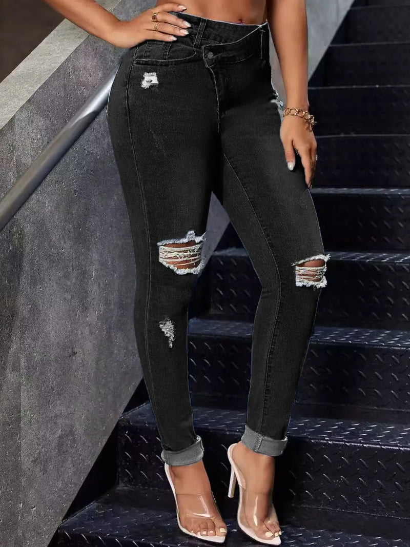 Person wearing black distressed jeans on a staircase