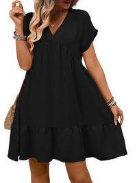 Black dress worn by a model on a white background