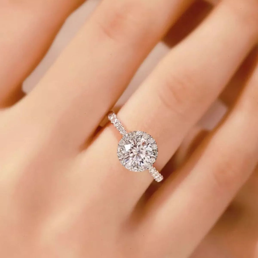 Silver ring with a large diamond on a hand