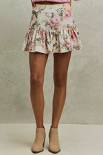 Floral skirt worn by a person on a neutral background