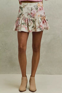 Floral skirt worn by a person on a neutral background