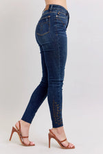 Blue jeans worn by a person on a light gray background