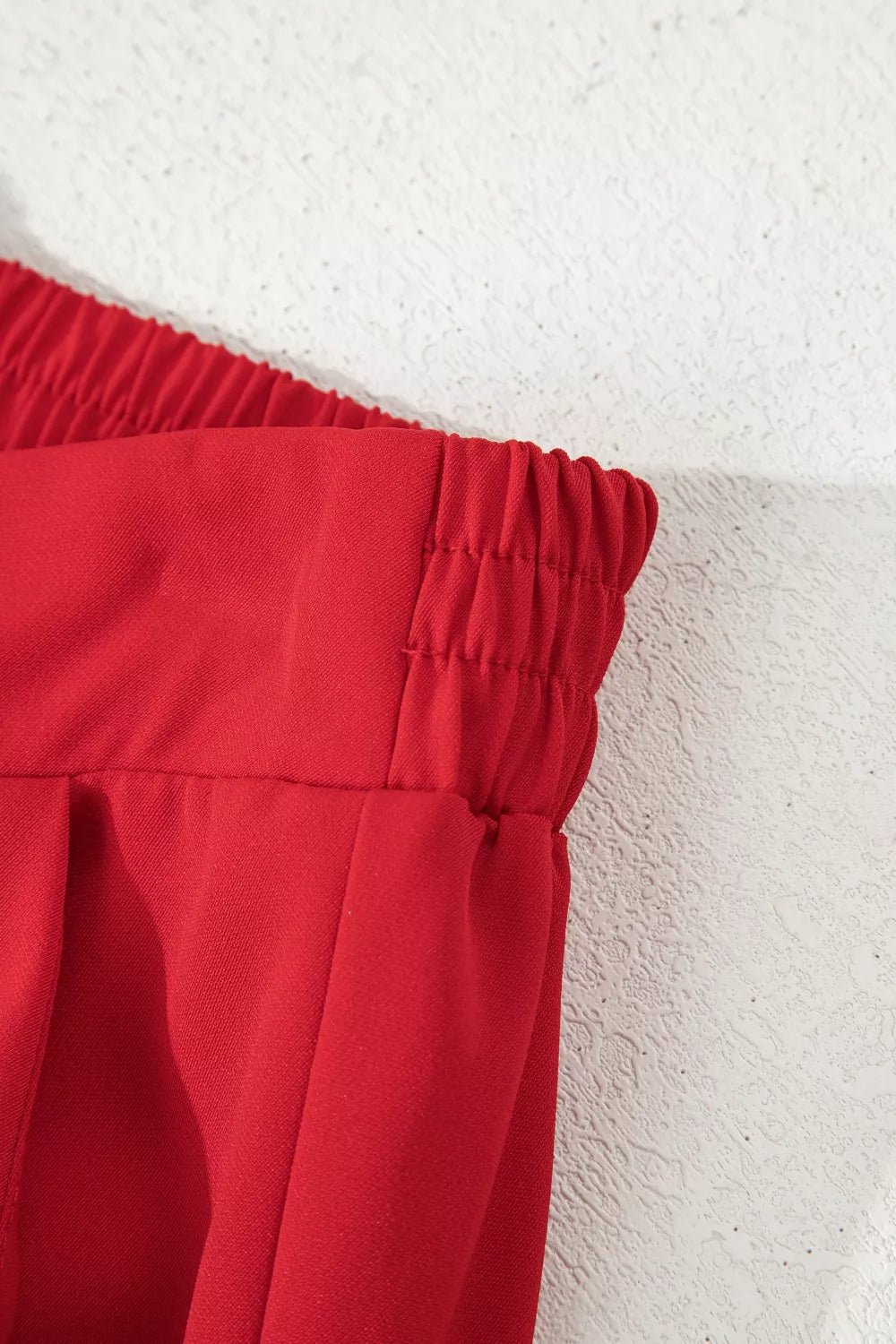 Red pants with a textured white background