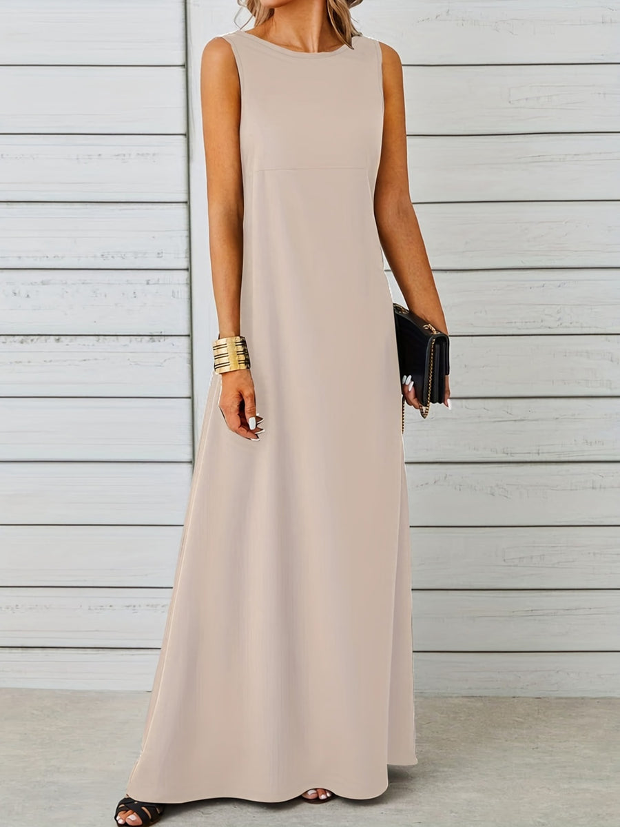 Woman wearing a beige sleeveless dress against a wooden background