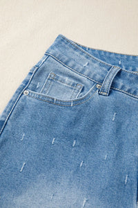 Close-up of blue denim jeans with a beige background