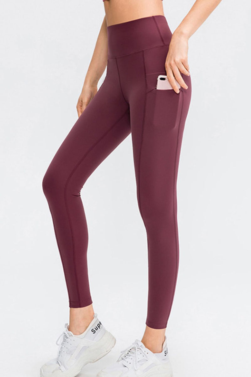 Maroon leggings worn by a person on a white background