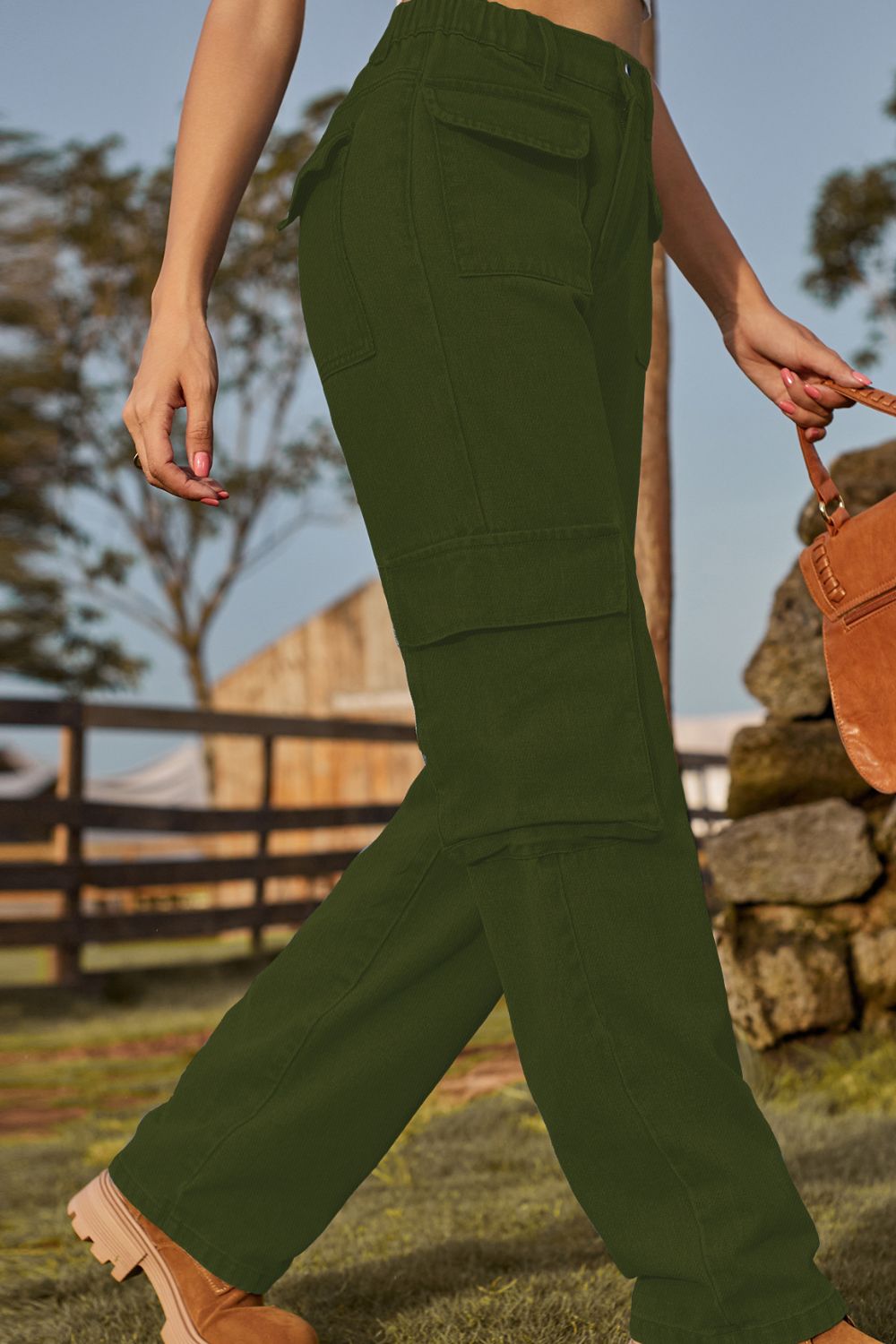 Person wearing green cargo pants with a rustic background