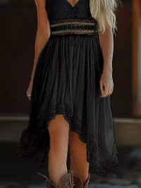 Black lace dress with a high-low hemline worn by a person.