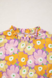Floral patterned fabric with orange, pink, and purple flowers on a white background