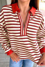 Person wearing a red and white striped shirt with a red collar.