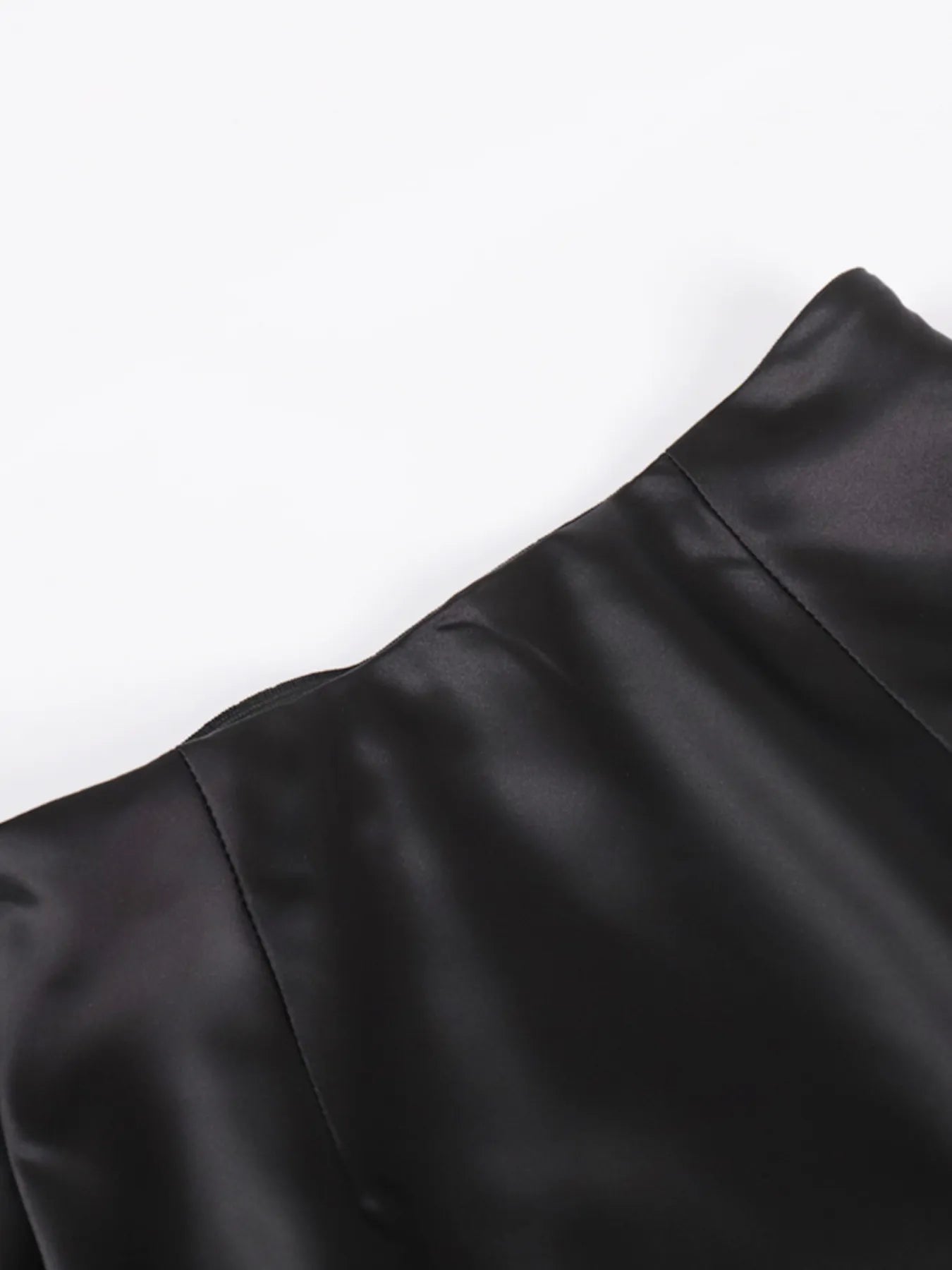 Close-up of a black satin fabric on a white background