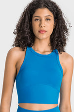 Woman wearing a blue athletic top against a white background