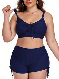 Woman wearing a navy blue bikini set on a white background