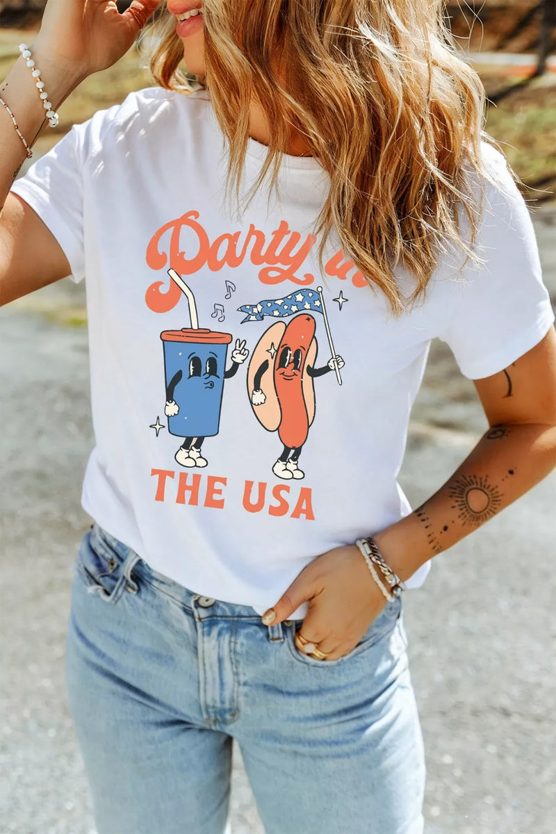 Person wearing a white t-shirt with 'Party in the USA' design, standing outdoors.