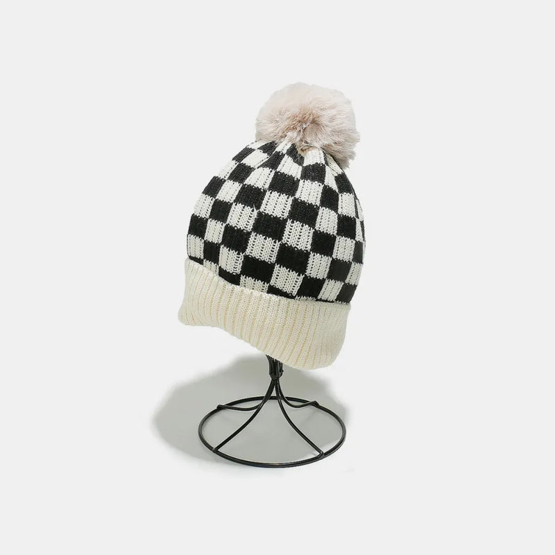 Checkered beanie with pom-pom on a white background