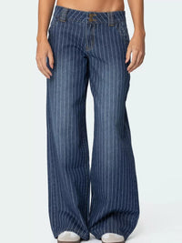 Blue pinstripe jeans worn by a person on a white background