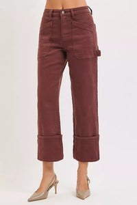 Brown pants worn by a person on a white background