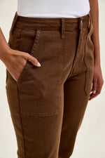 Brown pants worn by a person on a beige background